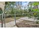 Fenced backyard featuring a concrete patio and lush foliage, offering privacy and outdoor enjoyment at 630 W Rich Ave, Deland, FL 32720