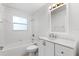 This bathroom includes a combination tub and shower with white vanity at 630 W Rich Ave, Deland, FL 32720