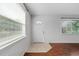 Foyer with tile and wood flooring, a large window, and a bright white front door at 630 W Rich Ave, Deland, FL 32720