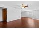 Bright living room featuring wood flooring, a ceiling fan, and natural light at 630 W Rich Ave, Deland, FL 32720