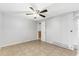 Open and airy living room with tiled floors and a ceiling fan at 630 W Rich Ave, Deland, FL 32720