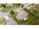 Aerial view of a single-story home with a screened-in lanai and mature landscaping in a quiet neighborhood at 66 Old Sunbeam Dr, South Daytona, FL 32119