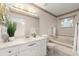 Well-lit bathroom with a marble vanity, soaking tub, and decorative accents at 66 Old Sunbeam Dr, South Daytona, FL 32119