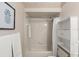 Bathroom featuring a tub-shower, white shelving, and neutral tile at 66 Old Sunbeam Dr, South Daytona, FL 32119