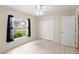 Bright bedroom with light tile floors, ceiling fan, and a double door closet at 66 Old Sunbeam Dr, South Daytona, FL 32119