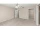 Neutral bedroom with a ceiling fan and doors to a walk-in closet at 66 Old Sunbeam Dr, South Daytona, FL 32119