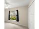 Bedroom with a ceiling fan, light-colored flooring, a window with dark curtains, and a closet with folding doors at 66 Old Sunbeam Dr, South Daytona, FL 32119