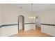 Neutral dining room featuring tile floors, decorative border and arched doorways at 66 Old Sunbeam Dr, South Daytona, FL 32119