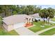 Lovely single Gathering with a two car garage, lush landscaping and lots of curb appeal at 66 Old Sunbeam Dr, South Daytona, FL 32119