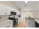 Bright kitchen with white cabinets, stainless steel appliances, tile backsplash, and tile flooring at 66 Old Sunbeam Dr, South Daytona, FL 32119