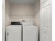 A laundry room equipped with a washing machine and dryer, providing convenience for household chores at 66 Old Sunbeam Dr, South Daytona, FL 32119