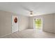 Bright living room featuring wood-look flooring and a sliding glass door for natural light at 66 Old Sunbeam Dr, South Daytona, FL 32119