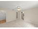 Large main bedroom featuring hard floors, ceiling fan, and doorway to a bathroom and closet at 66 Old Sunbeam Dr, South Daytona, FL 32119