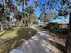 A concrete path winds through a beautifully landscaped park with lush foliage and native landscaping at 66 Old Sunbeam Dr, South Daytona, FL 32119