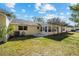 Backyard with partial view of the home and the enclosed sunroom at 8885 Sw 95Th St # C, Ocala, FL 34481