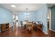 Bright dining room featuring a modern chandelier, hardwood floors and backyard access at 8885 Sw 95Th St # C, Ocala, FL 34481