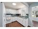 Well-lit kitchen with white appliances and a view of the sunroom at 8885 Sw 95Th St # C, Ocala, FL 34481