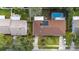 Aerial view of a home with a brown roof, solar panels, and a backyard pool at 1054 W Samms Ave, Port Orange, FL 32129