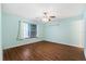 Bedroom features a ceiling fan, window with blinds, and light blue walls at 1054 W Samms Ave, Port Orange, FL 32129