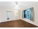 Bright bedroom with ceiling fan, wood floors, and a window with views of the outdoors at 1054 W Samms Ave, Port Orange, FL 32129