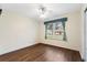 Cozy bedroom with hardwood floors and a bright window at 1054 W Samms Ave, Port Orange, FL 32129