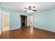 Light blue bedroom features ceiling fan, closet and wood flooring at 1054 W Samms Ave, Port Orange, FL 32129