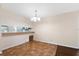 Dining area featuring tile flooring, a hanging chandelier, and a view into the adjacent kitchen and living room at 1054 W Samms Ave, Port Orange, FL 32129