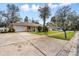 A charming single-Gathering home with a spacious driveway and well-manicured front yard at 1054 W Samms Ave, Port Orange, FL 32129