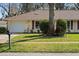 Exterior shot of a cozy home with a lush green lawn, a mailbox, and an attached single-car garage at 1054 W Samms Ave, Port Orange, FL 32129