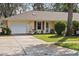 Cozy home with a well-maintained lawn, attached garage, and a welcoming entrance, perfect for first-time buyers at 1054 W Samms Ave, Port Orange, FL 32129