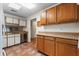 Traditional kitchen showcasing tile floors, wood cabinets, stainless steel dishwasher and ample counter space at 1054 W Samms Ave, Port Orange, FL 32129