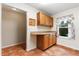 Eat-in kitchen area with wooden cabinets, tile floor, and a window providing natural light at 1054 W Samms Ave, Port Orange, FL 32129