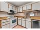 Kitchen featuring white cabinetry, updated appliances, and stainless steel dishwasher at 1054 W Samms Ave, Port Orange, FL 32129