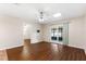 Bright living room with laminate flooring, ceiling fan and sliding doors leading to the outdoors at 1054 W Samms Ave, Port Orange, FL 32129