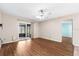 Bright living room with wood floors and sliding glass door to screened porch at 1054 W Samms Ave, Port Orange, FL 32129