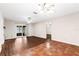 Open-concept living room with laminate flooring, ceiling fan, and access to a screened porch at 1054 W Samms Ave, Port Orange, FL 32129