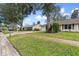 Neighborhood street view featuring well-manicured lawns and landscaping at 1054 W Samms Ave, Port Orange, FL 32129