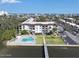 Aerial view of the condo, community pool, landscaping, and waterfront dock at 118 S Halifax Ave # 103, Daytona Beach, FL 32118
