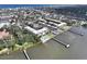 Aerial view of a waterfront condominium with a pool, docks, and coastal neighborhood at 118 S Halifax Ave # 103, Daytona Beach, FL 32118