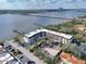 Aerial view showcasing the condo with water views, surrounding neighborhood and parking at 118 S Halifax Ave # 103, Daytona Beach, FL 32118