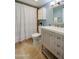 Clean bathroom featuring neutral tones, tiled floors and a vanity with lots of storage at 118 S Halifax Ave # 103, Daytona Beach, FL 32118