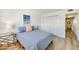 Cozy bedroom with wood floors, closet, and access to the hallway at 118 S Halifax Ave # 103, Daytona Beach, FL 32118