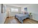 Bright bedroom featuring wood floors, a large window and beach themed decor at 118 S Halifax Ave # 103, Daytona Beach, FL 32118