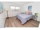 Well lit bedroom featuring wood floors, a large window, and stylish decor at 118 S Halifax Ave # 103, Daytona Beach, FL 32118