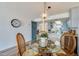 View of dining area with glass table, wicker chairs, and a barn door accent at 118 S Halifax Ave # 103, Daytona Beach, FL 32118