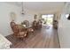 Open concept dining room leading to waterfront living room with sliding glass door at 118 S Halifax Ave # 103, Daytona Beach, FL 32118
