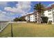 Well-maintained condo building with lush green lawn and a beautiful pool area at 118 S Halifax Ave # 103, Daytona Beach, FL 32118