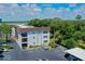 Condo building featuring well-maintained landscaping and designated parking spaces at 118 S Halifax Ave # 103, Daytona Beach, FL 32118
