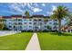 Exterior shot of condo building featuring balconies and manicured lawn at 118 S Halifax Ave # 103, Daytona Beach, FL 32118