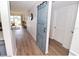 Hallway view showing a rustic blue sliding barn door and light wood colored floors at 118 S Halifax Ave # 103, Daytona Beach, FL 32118